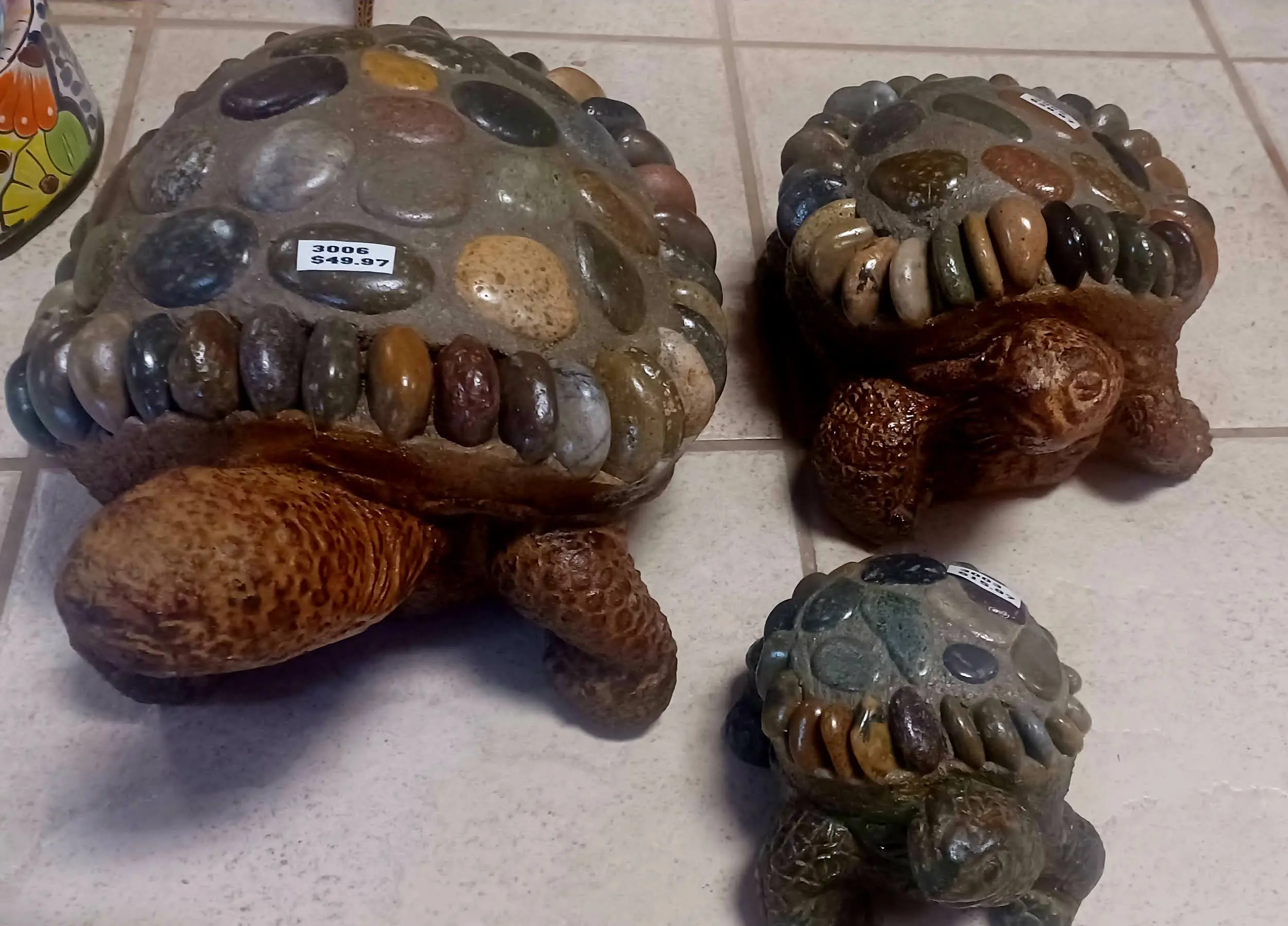Three clay turtles with stones in their shells